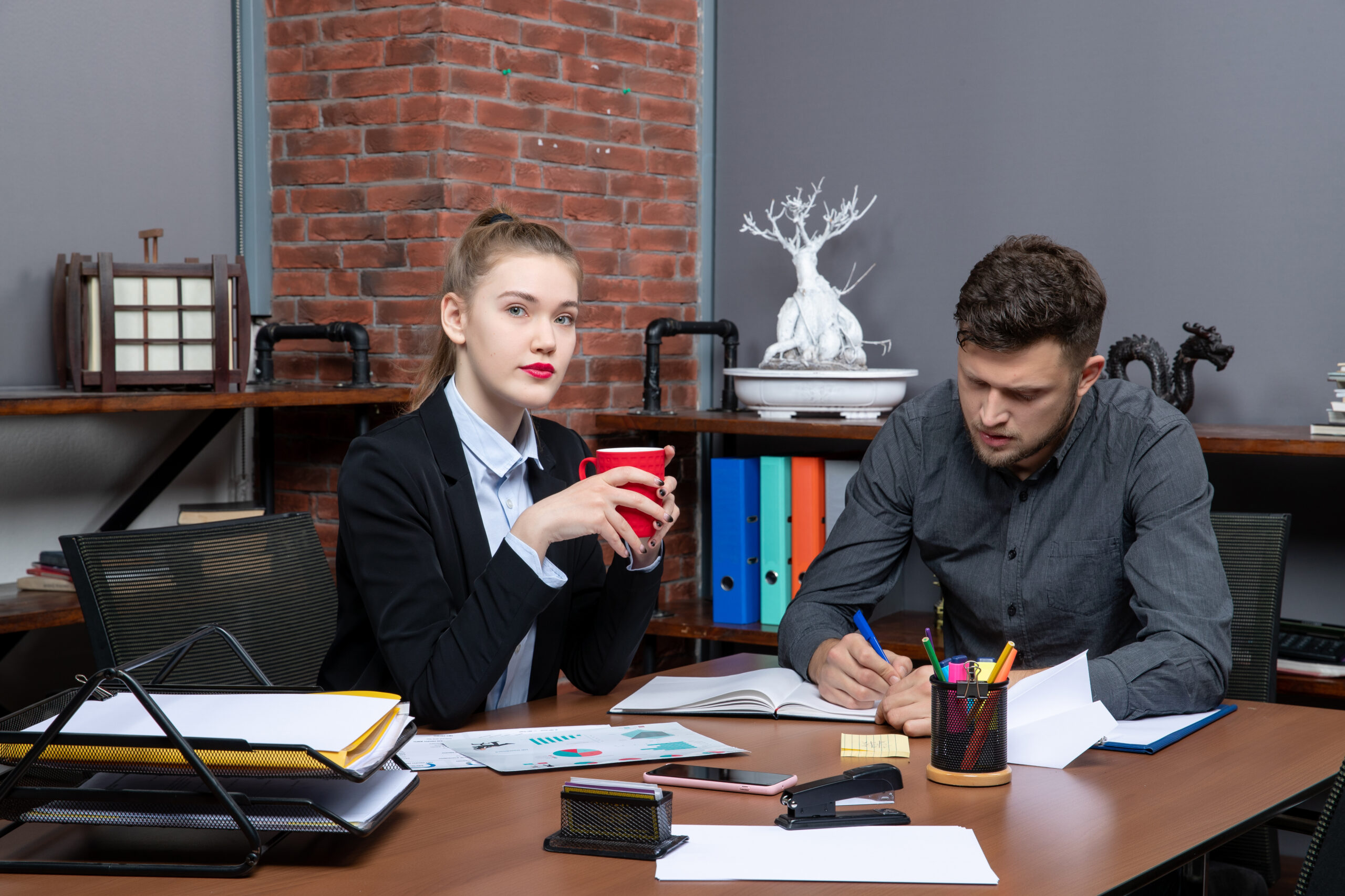 hardworking-serious-professional-workers-discussing-one-issue-documents-office