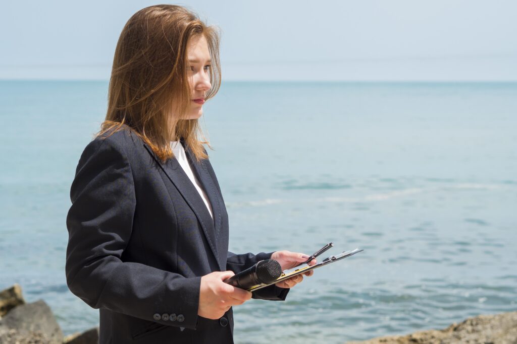 reporter-holding-notepad-by-sea